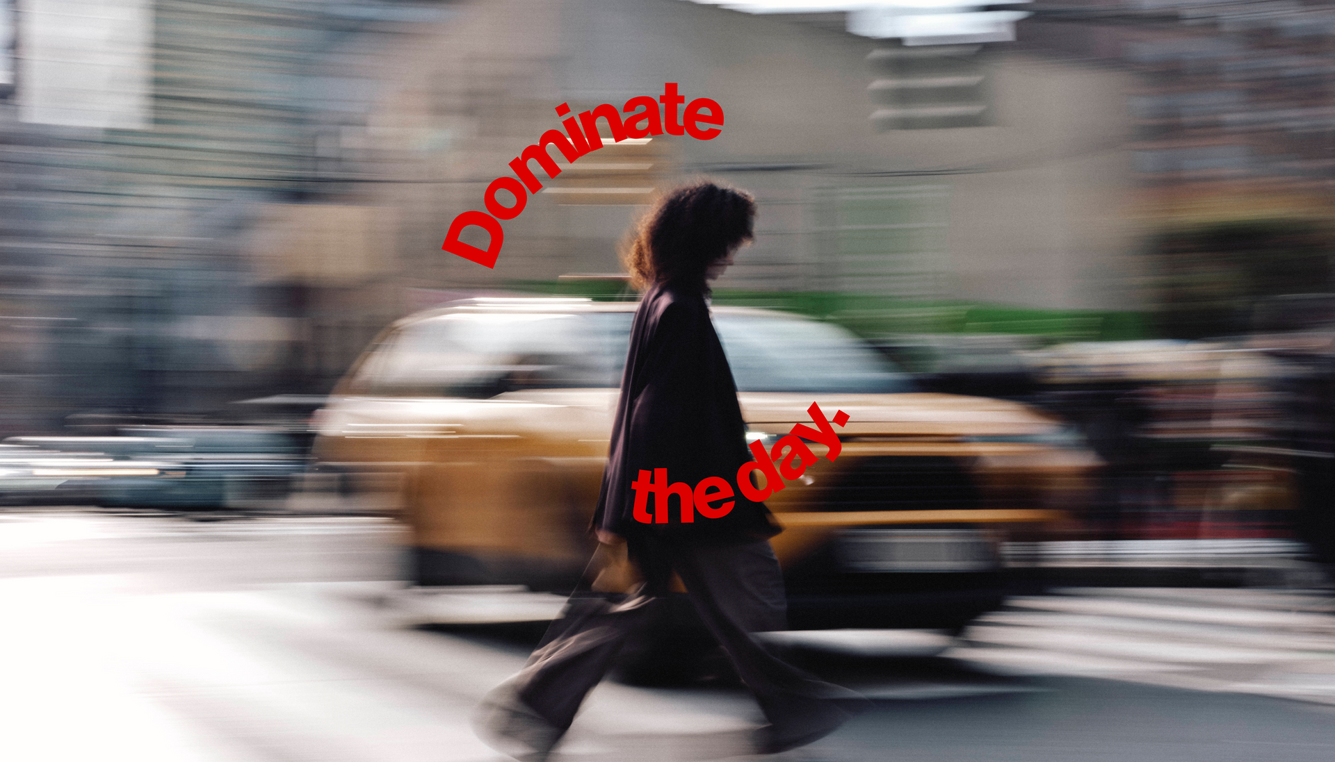 Person walking on a city street with 'Dominate the day' text overlay